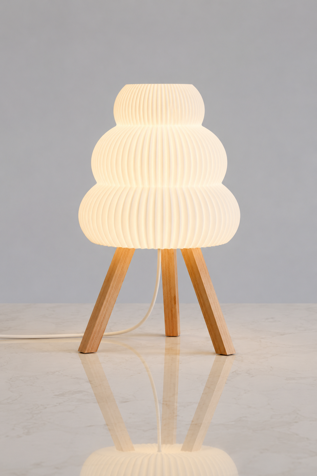 Modern floor lamp with ribbed white shade and wooden legs on a light gray background